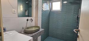 a bathroom with a sink and a shower at ATLANTIC Apartments in Štip