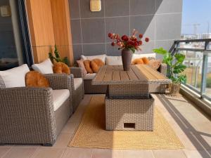 a balcony with a table and chairs on a balcony at Casa Custodio in Olhão