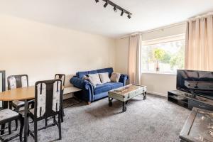a living room with a blue couch and a table at St Johns Ct in Warwick