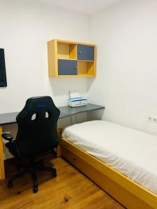 a bedroom with a desk and a chair next to a bed at Casa Leo in Almería