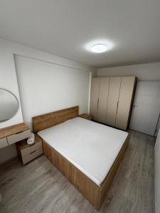 a small room with a bed and cabinets at Nest Apartments - FK Commodity in Kosovo Polje