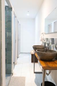two sinks in a bathroom with a hallway at Modular Dreams in Madrid