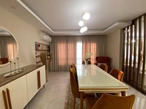 a kitchen and dining room with a table and chairs at Luxury Duplex in Cairo