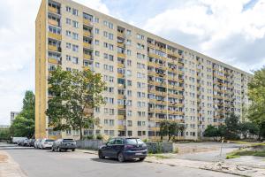 a large building with cars parked in front of it at Markowska by VAYA STAYS in Warsaw