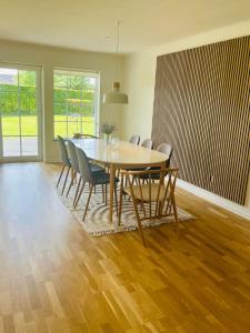 a dining room with a table and chairs at Charmende villa in Herning +8 photos