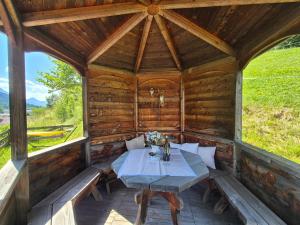 a wooden porch with a table in a cabin at Appartementhaus Klammer in Sillian
