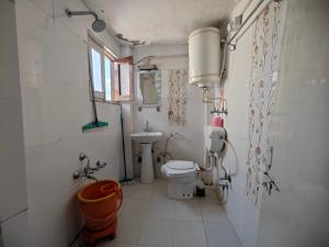 a small bathroom with a toilet and a sink at Lake Boulevard Guest House in Srinagar +75 photos