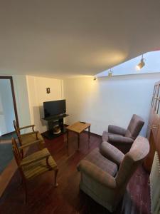 a living room with a couch and a tv at Alojamiento centro Bariloche in San Carlos de Bariloche