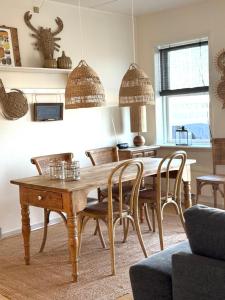 a dining room with a wooden table and chairs at Udsigten in Rudkøbing +23 photos