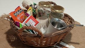 a basket filled with condiments and jars of water at Bom Descanso in Realicó