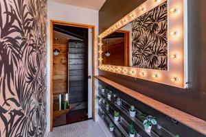 a hallway with a staircase with a mirror on the wall at Chic Home with King Bed and Fire Pit in Pittsburgh