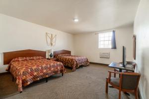 a hotel room with two beds and a window at Hotel O Colonial Inn Brownsville Tx in Brownsville