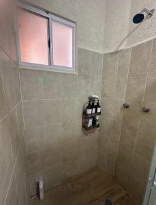 a bathroom with a shower with a window at Departamento en Zona Diamante Acapulco in Acapulco +1 photo