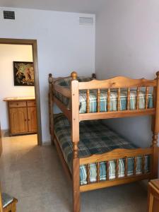 a couple of bunk beds in a room at Apartament L'Ampolla BLAU a 50 m del MAR, WIFI, parking in L'Ampolla