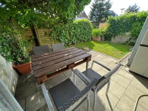 a wooden table and chairs on a patio at Tobi‘s Ferienapartment in Gottmadingen
