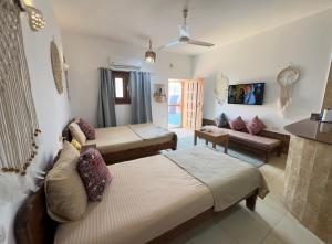 a living room with two beds and a couch at Lighthouse Residence in Dahab