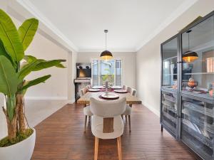 a dining room with a table and a plant at OC Heated Pool,Fire Pit,Spa,BBQ,Disney,Beaches in Mission Viejo