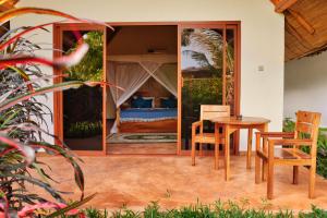 a room with a bed and a table and chairs at Kidoti Bay in Kidoti +43 photos