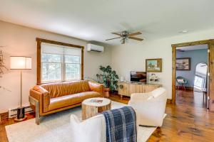 a living room with a leather couch and chairs at Walk to River Couples Retreat in Kintnersville! in Kintnersville