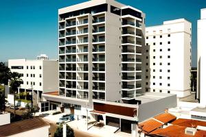 a large white apartment building in a city at Flat 602 - Mn Concept in Marília