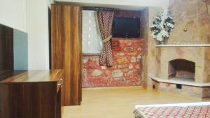 a room with a fireplace and a room with a bed at Odunluk Tas Konak Hotel in Dalyanköy