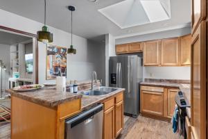 a kitchen with wooden cabinets and a stainless steel refrigerator at Coffee Themed - Cozy Family Getaway - Sleeps 12 - Mini Golf BBQ Yard in Westminster