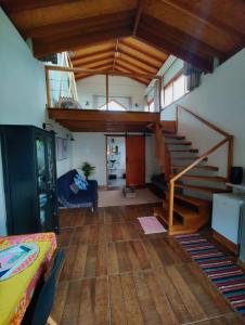 a living room with a staircase in a house at Chalés Ninho do Poeta in Gonçalves
