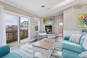 a living room with a couch and chairs and a table at 7078 - Island Time in Nags Head