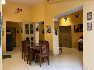 a dining room with a table and chairs at Cozy Inn in Varanasi