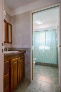 a bathroom with a toilet and a sink and a shower at Casa en las sierras de Merlo in Merlo