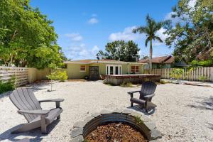 dos sillas y una hoguera en un patio trasero en Manatee Bungalow, en Bradenton