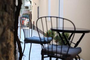 two chairs and a table on a patio at Point Apartman in Belgrade