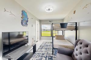 sala de estar con TV, sofá y sofá en Dog friendly -waterfont home with a private dock, work station , W/D and WIFI, en Palm Coast