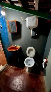 a small bathroom with a toilet and a sink at Casa Rústica in Encarnación