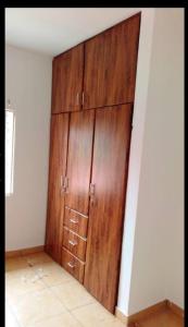 a large wooden cabinet in the corner of a room at AbbottsPlace in Ashaiman
