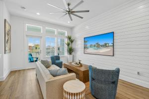 a living room with a couch and chairs and a tv at Sunset Shores Escape in Port Aransas