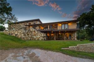 a large stone house with a stone wall at Hillview Estate in Granite Shoals