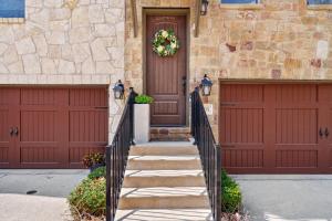 a house with two garage doors and a wreath on the door at Modern Luxury Townhouse with Private Elevator and Rooftop Terrace in Georgetown