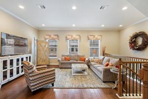 a living room with a couch and a tv at Modern Luxury Townhouse with Private Elevator and Rooftop Terrace in Georgetown +35 photos
