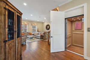 an open door to a living room with a couch at Modern Luxury Townhouse with Private Elevator and Rooftop Terrace in Georgetown