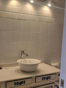 a bathroom with a white sink and a mirror at Loft Quintanar in Quintanar del Rey