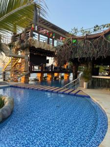 a swimming pool at a resort with a slide at Aves de Laguna Beach in Tierralta