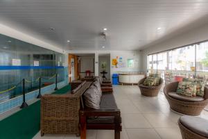 a large room with couches and a pool table at Mar Hotel in Balneário Camboriú