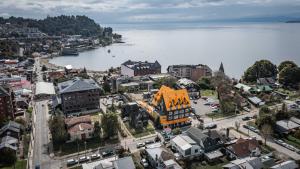 an aerial view of a town next to a body of water at Hotel Museo El Greco Puerto Varas in Puerto Varas