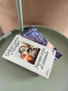 a magazine and a book sitting on a table at Casa CuOr in Senigallia