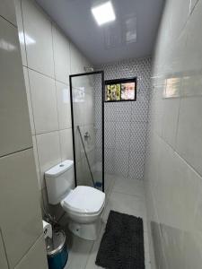 a small bathroom with a toilet and a shower at Ap Centro in Ciudad del Este +12 photos