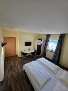 a hotel room with a bed and a desk at Gasthof Hochstein in Meschede