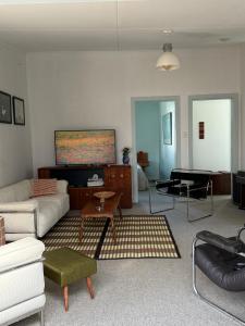 a living room with a couch and a table at Clive Cottage in Clive