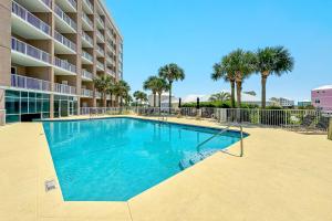 a swimming pool in front of a apartment building at The Dunes Unit 104 in Gulf Shores