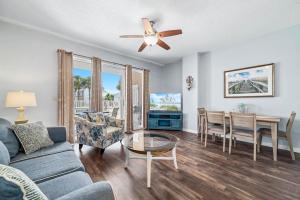 a living room with a couch and a table at The Dunes Unit 104 in Gulf Shores +32 photos